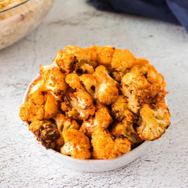 Bowl of Air Fryer Tandoori Cauliflower (Gobi Tikka) with golden-brown, crispy pieces of cauliflower coated in a spiced yogurt marinade.