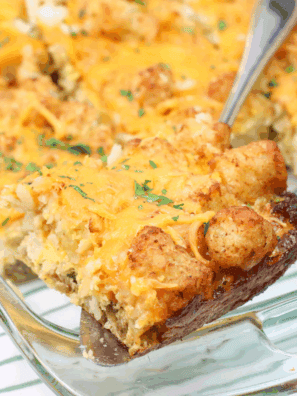 Cheesy air fryer tater tot casserole in a baking dish with golden, crispy tots on top.