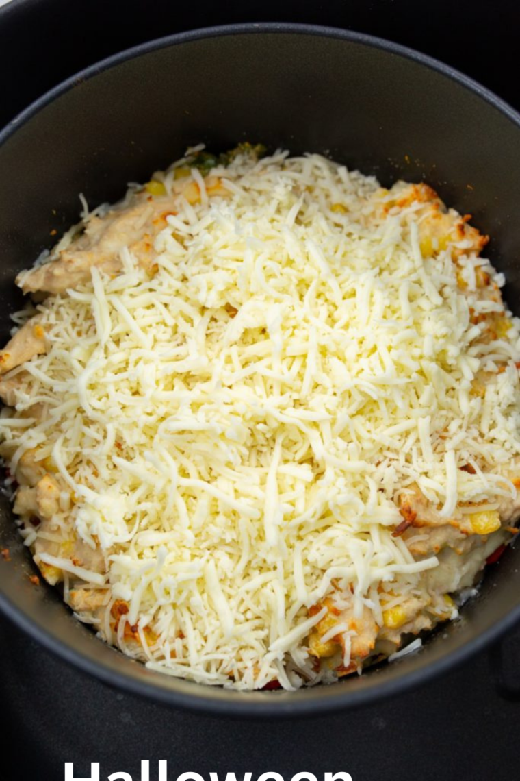 Air Fryer White Chicken Chili Dip cooking in an air fryer basket.