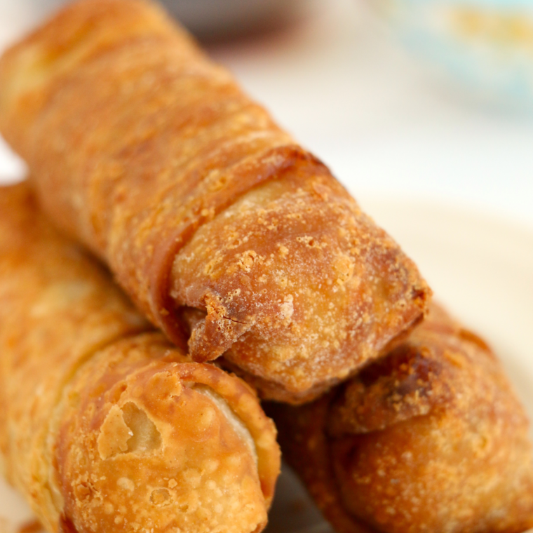 Golden brown Chung's egg rolls resting on a plate after air frying