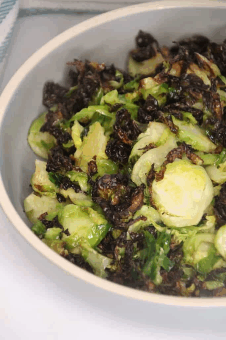 Crispy shaved Brussels sprouts cooked in an air fryer, golden and seasoned