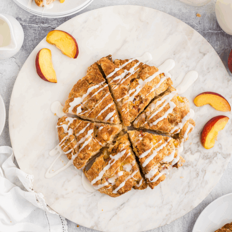 Plated peach scones served with glaze or butter.