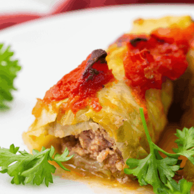 Air fryer stuffed cabbage rolls on a plate, filled with seasoned ground meat and rice, ready to serve.