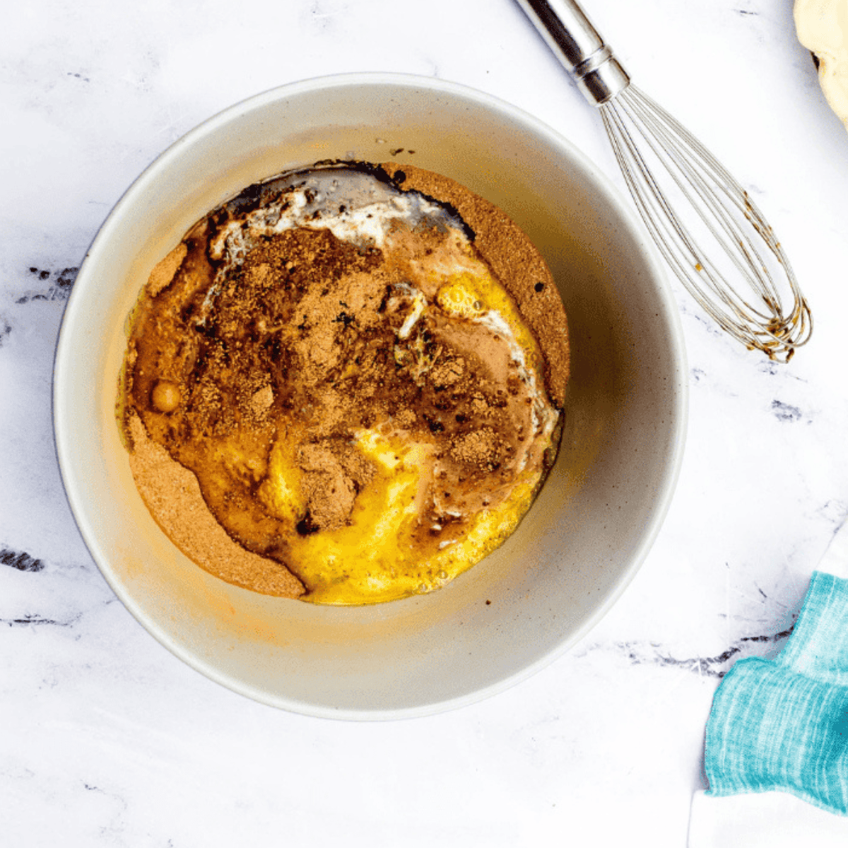 Adding egg, melted butter, evaporated milk, and vanilla, then stirring until fully combined.