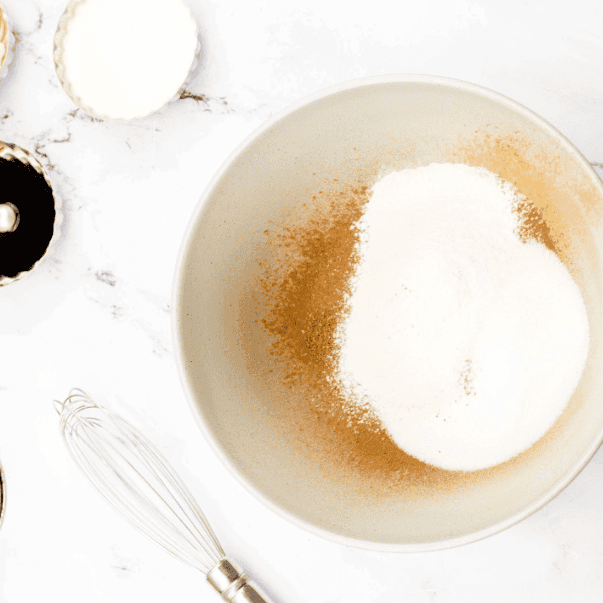 Melting butter in a microwave-safe bowl and whisking cocoa powder, sugar, and flour in another bowl.
