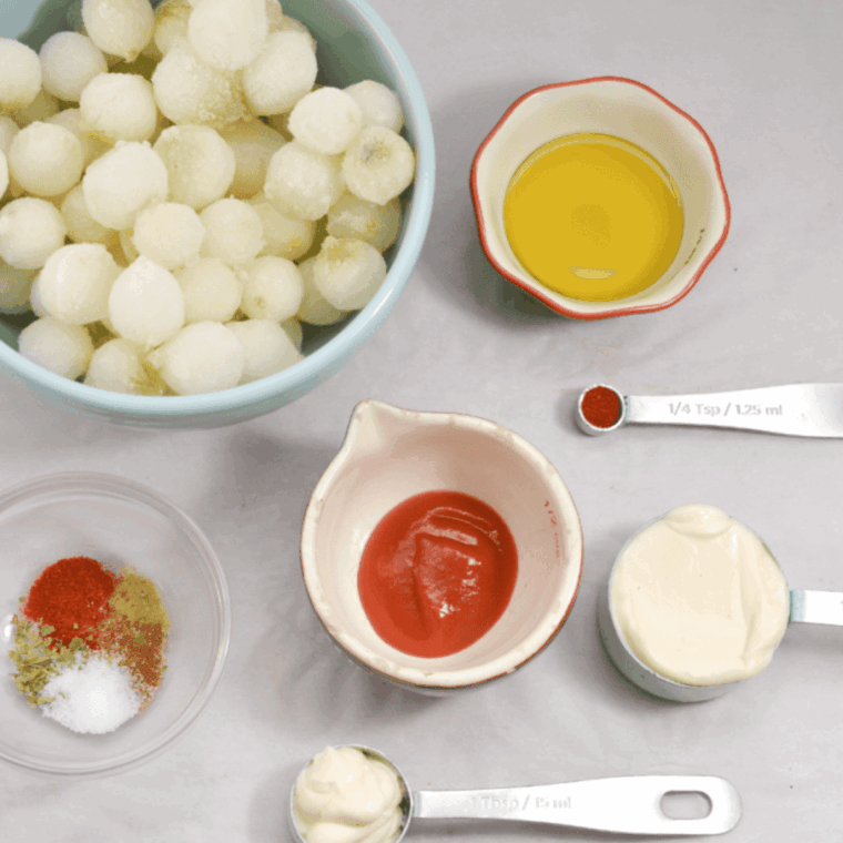 Ingredients needed for Air Fryer Pearl Onions Recipe on kitchen table.