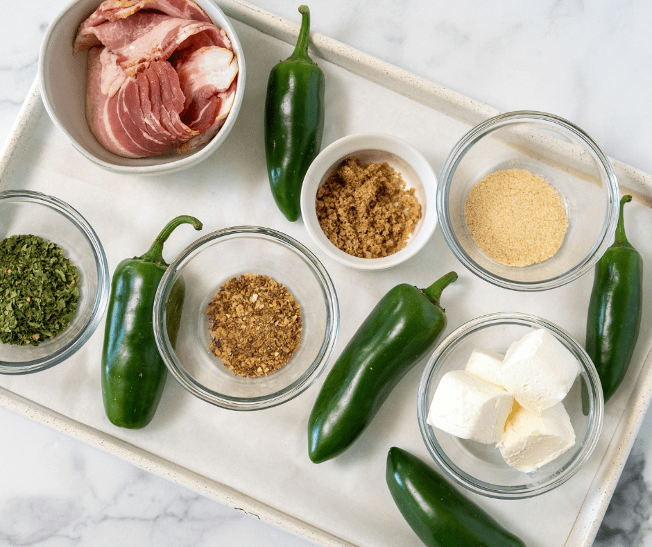 Stuffed jalapeno peppers ingredients on a white tray.