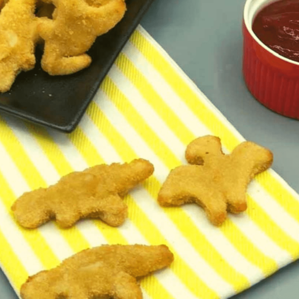 Here are cooking instructions for Dino Nuggets using three different methods: Microwave, Air Fryer, and Stove.

Microwave Cooking Instructions:

Microwaving Dino Nuggets is the quickest option, but it may not result in the same level of crispiness as other methods.

Arrange Nuggets: Place a single layer of Dino Nuggets on a microwave-safe plate.

Cover with a Microwave-Safe Cover or Microwave-Safe Paper Towel: Cover the nuggets to prevent splattering.

Microwave: Cook on high power for approximately 1-2 minutes per serving. Cooking times may vary depending on the microwave's wattage and the number of nuggets. Rotate the nuggets halfway through the cooking time for even heating.

Check for Doneness: Carefully remove the plate from the microwave, and use caution when uncovering it to avoid steam burns. Check the nuggets for doneness. They should be hot throughout.

Serve: Allow the nuggets to cool for a minute or two before serving. Enjoy with your favorite dipping sauces.

Air Fryer Cooking Instructions:

Cooking Dino Nuggets in an air fryer results in a crispy texture and is preferred by many for its taste and texture.

Preheat the Air Fryer: Preheat your air fryer to around 400°F (200°C) for 3-5 minutes.

Arrange Nuggets: Place a single layer of Dino Nuggets in the air fryer basket, ensuring they are not overcrowded.

Air Fry: Cook for approximately 7-10 minutes, flipping the nuggets halfway through the cooking time. Cooking times may vary based on the air fryer model and nugget size.

Check for Crispiness: Check the nuggets for crispiness and golden-brown color. Cook for an additional 1-2 minutes if needed.

Serve: Once the Dino Nuggets are crispy and cooked to your liking, remove them from the air fryer and serve hot with your favorite sauces.

Stove Cooking Instructions:

Cooking Dino Nuggets on the stove provides a stovetop-fried texture.

Heat Skillet: Heat a skillet or frying pan over medium heat and add a small amount of cooking oil.

Arrange Nuggets: Place a single layer of Dino Nuggets in the hot skillet, ensuring they are not overcrowded.

Pan-Fry: Cook the nuggets for about 3-4 minutes on each side, or until they are golden brown and crispy.

Check for Doneness: Check the nuggets for doneness by cutting into one to ensure it's hot throughout.

Serve: Once the Dino Nuggets are cooked to your satisfaction, remove them from the skillet and serve immediately with your preferred dipping sauces.

Choose the cooking method that suits your preferences and equipment, and enjoy your Dino Nuggets hot and delicious!