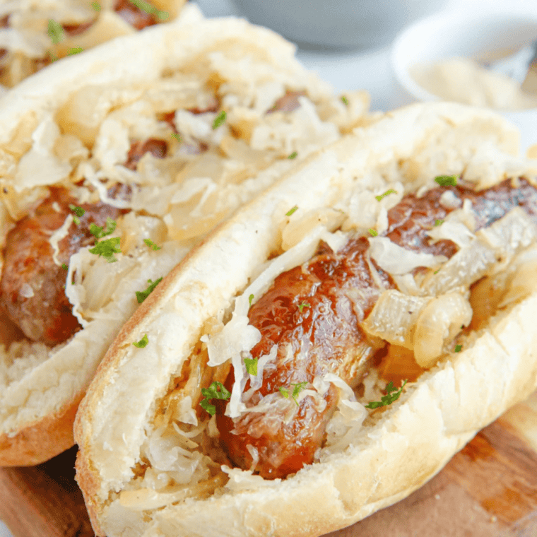 Air fryer brats topped with sauerkraut in a toasted bun