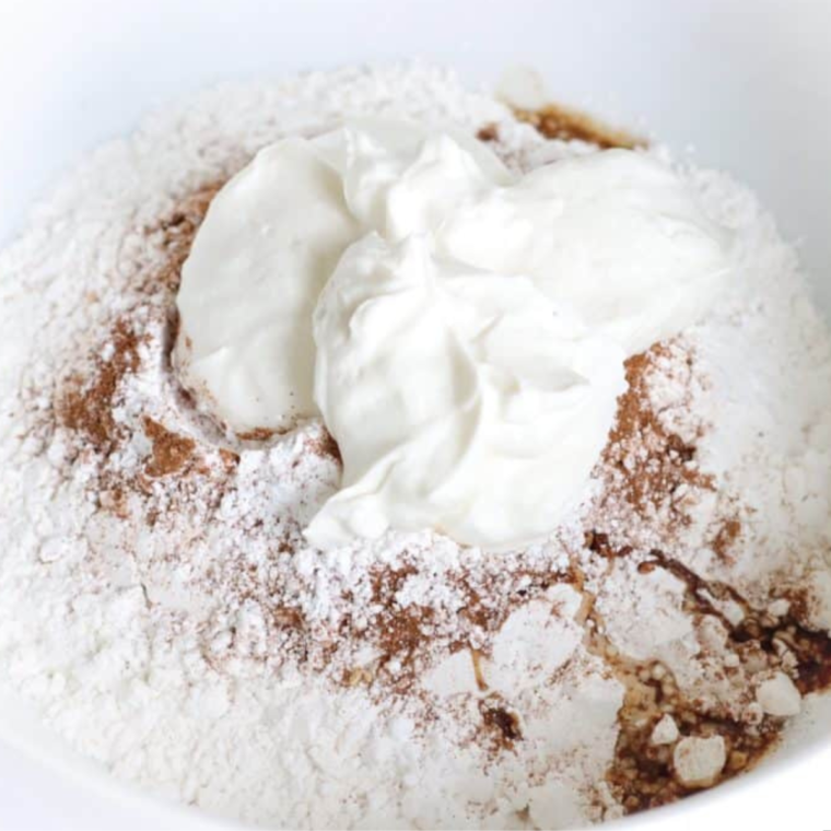 Mixing self-rising flour, Greek yogurt, and spices to form the bagel dough