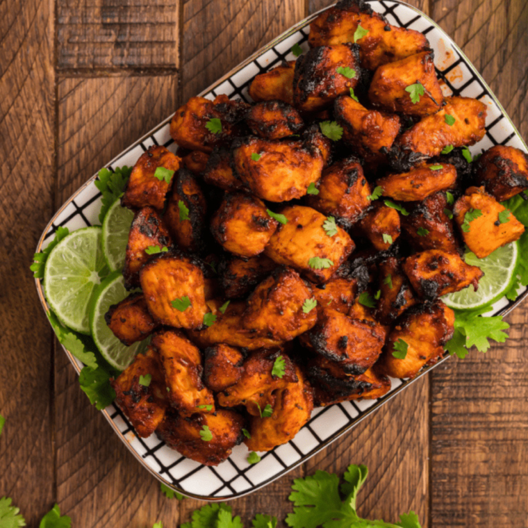 Serving delicious Air Fryer BBQ Chicken Bites with dipping sauce on the side.