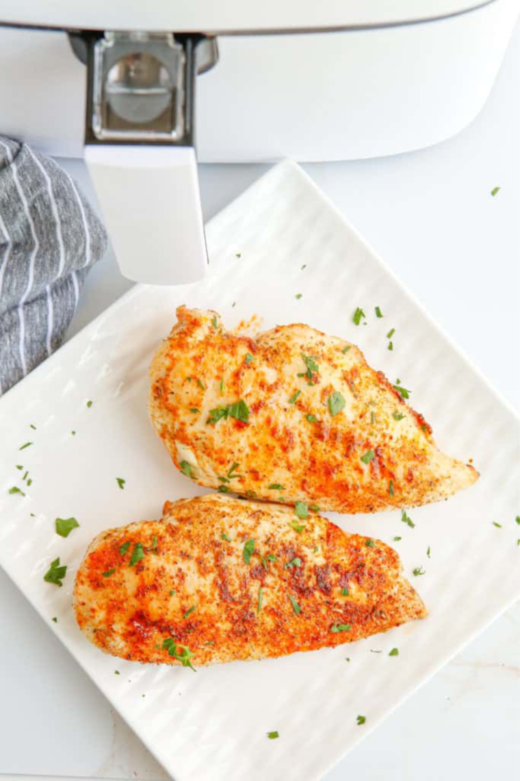 Air fryer butterflied chicken breast cooked to golden perfection, served on a plate with a crispy, juicy texture