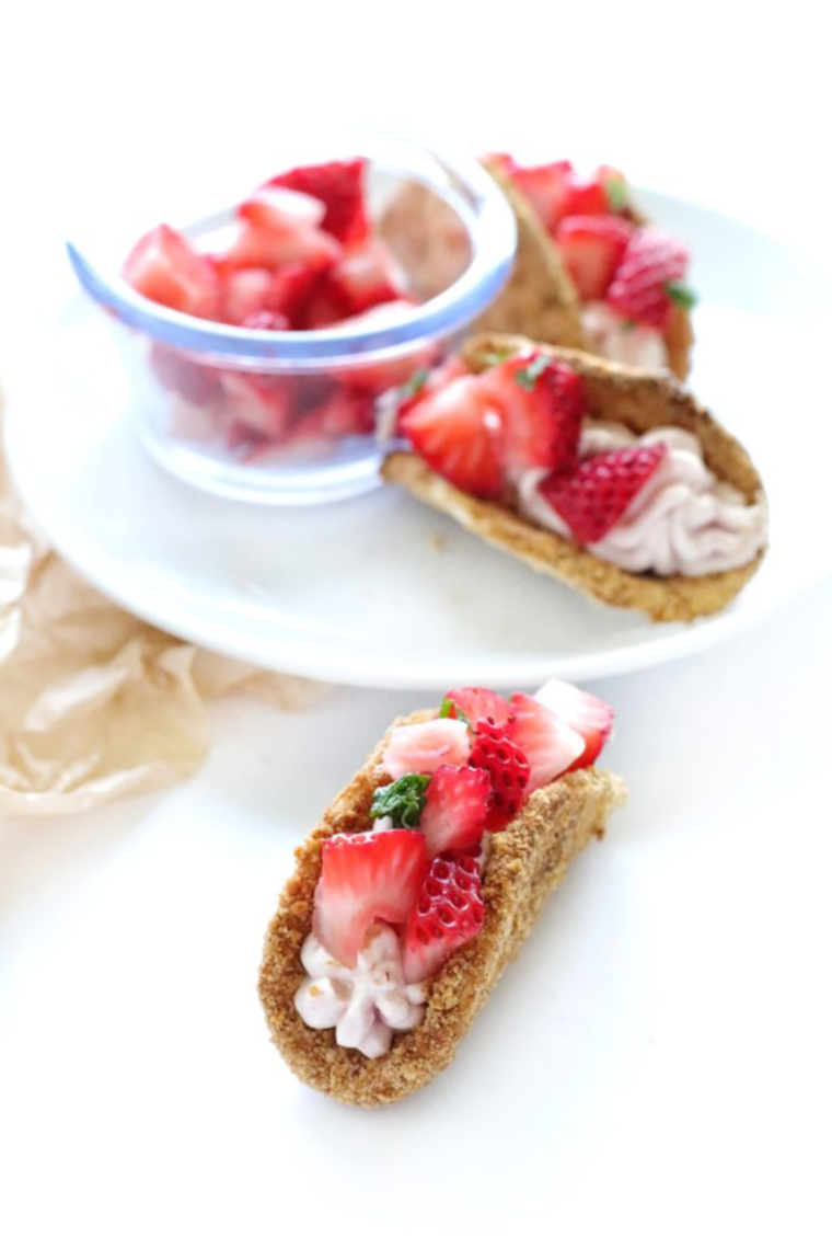 Air Fryer Cheesecake Strawberry Tacos with crispy graham cracker-coated shells, strawberry cheesecake filling, and fresh diced strawberries.