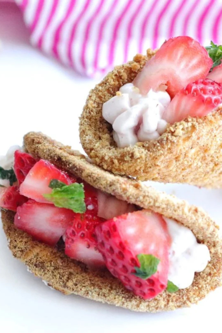 Air Fryer Cheesecake Strawberry Tacos filled with creamy cheesecake and topped with fresh strawberries in crispy taco shells.