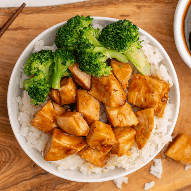 Air fryer chicken teriyaki bowl with glazed chicken, rice, and steamed vegetables in a white serving bowl.
