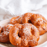 Air fryer copycat Auntie Anne's pretzels brushed with butter and sprinkled with coarse salt on a plate
