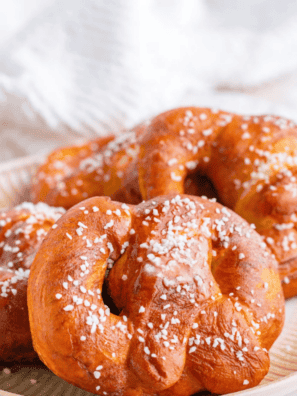 Air fryer copycat Auntie Anne's pretzels brushed with butter and sprinkled with coarse salt on a plate