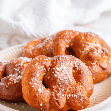 Air fryer copycat Auntie Anne's pretzels brushed with butter and sprinkled with coarse salt on a plate