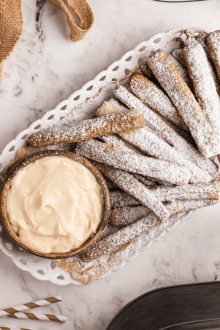 Golden and crispy Air Fryer Funnel Cake Fries, dusted with powdered sugar, ready to enjoy as a sweet treat or dessert.
