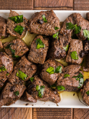 Juicy steak bites tossed in garlic butter sauce, freshly cooked in an air fryer with a crisp seared exterior.