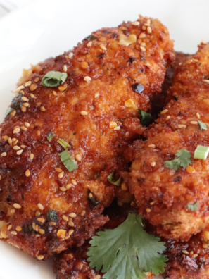 "Plate of crispy Air Fryer Korean Sticky Chicken Fingers with a sweet glaze"