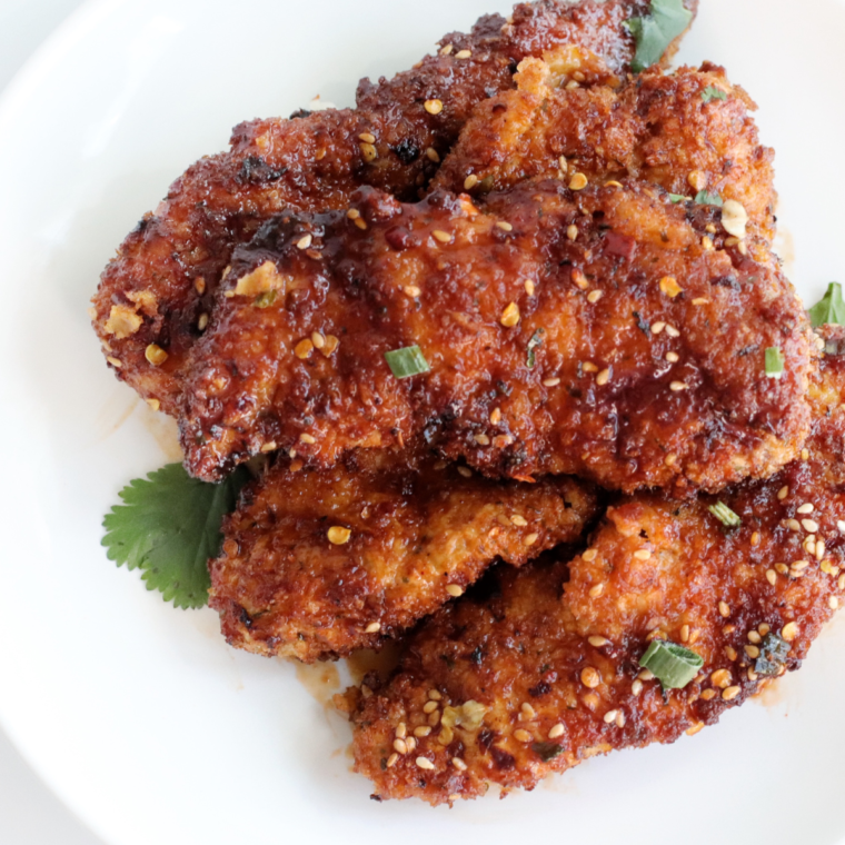 Plate of crispy Air Fryer Korean Sticky Chicken Fingers with a sweet glaze"