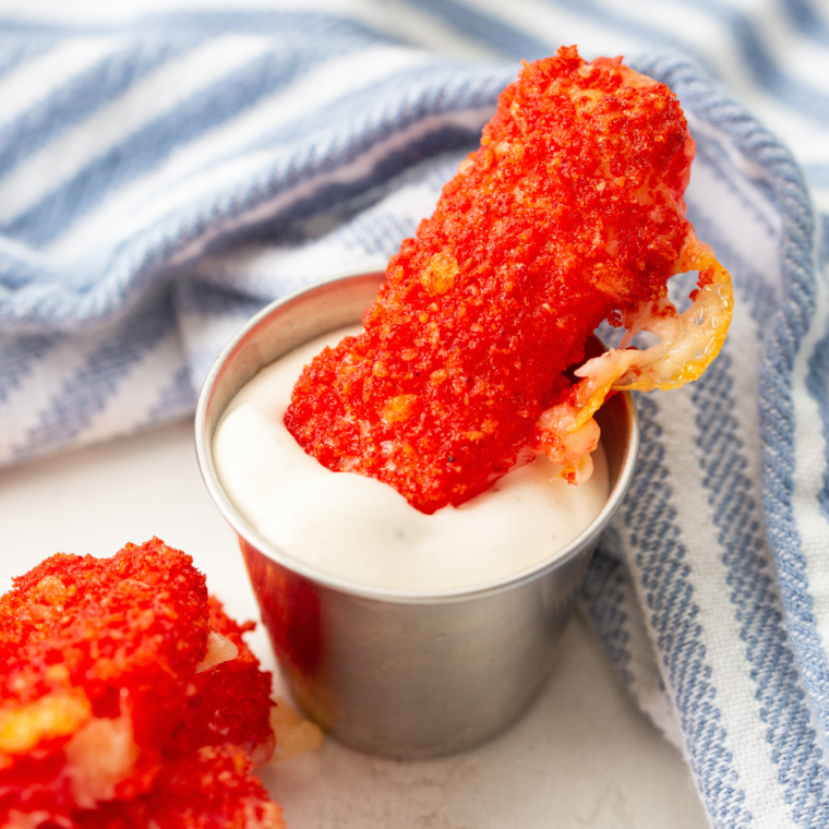 Air Fryer Takis Mozzarella Sticks with a spicy, crunchy Takis coating and gooey melted cheese inside.