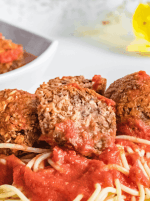 Air fryer vegan meatballs cooked to golden perfection, served on a plate with marinara sauce