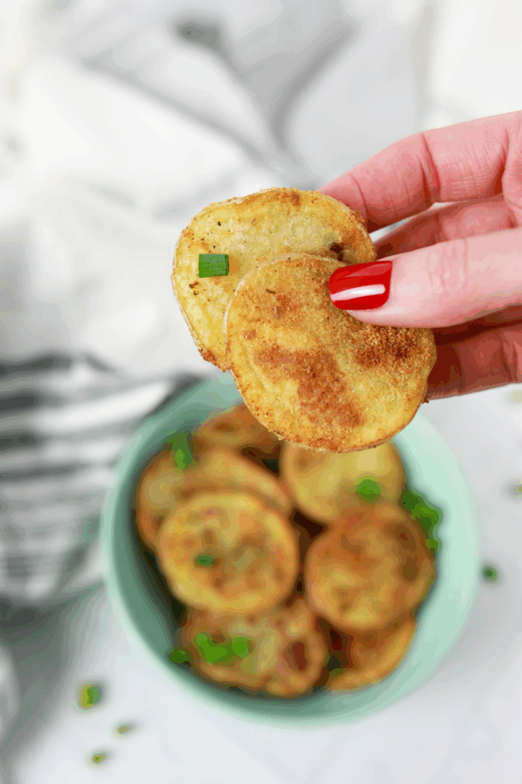 Golden, crispy air fryer sour cream and onion potato chips in a bowl.
