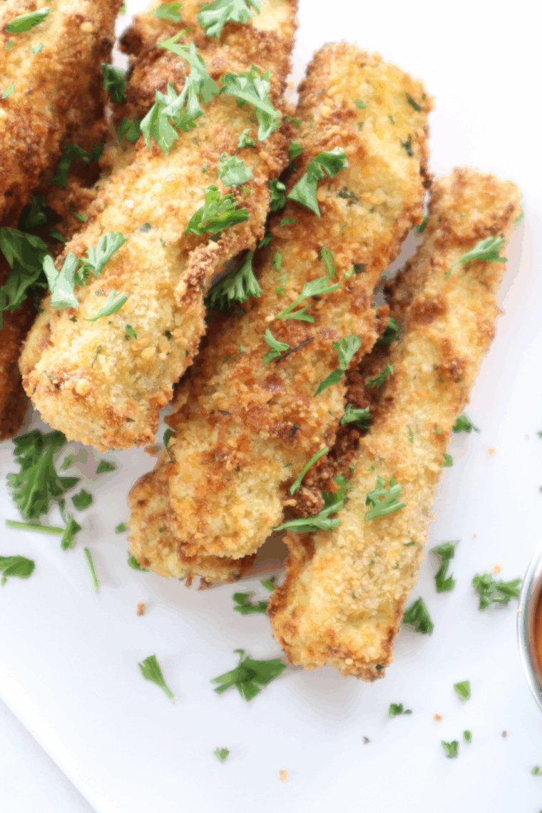 Crispy golden air fryer eggplant fries served on a plate with dipping sauce