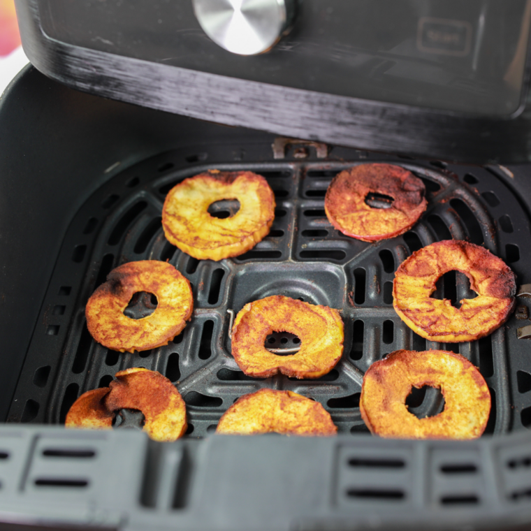 Air fryer cinnamon apple chips arranged on a cooling rack