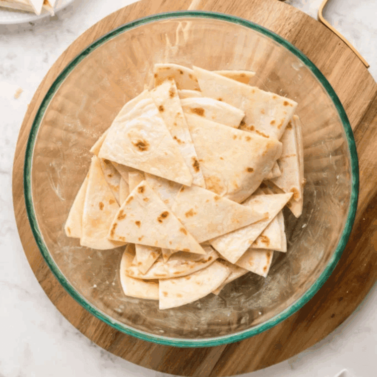 Tossing flour tortillas in melted butter and vanilla mixture.