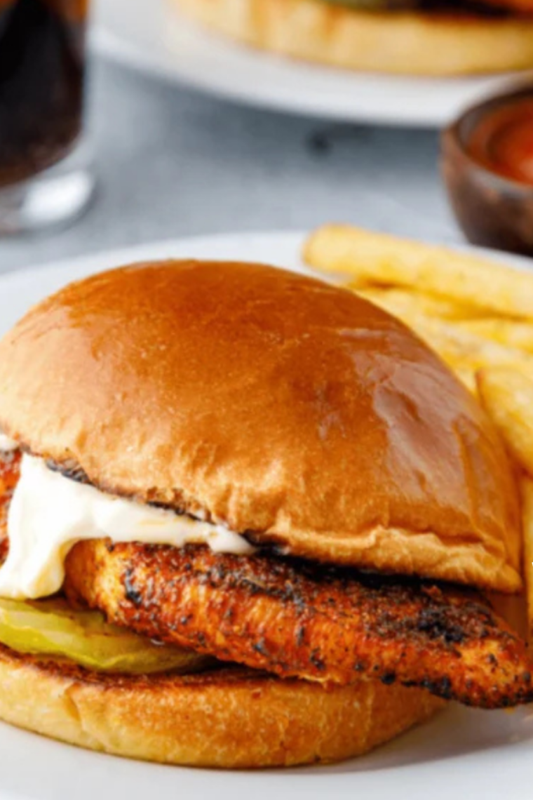 Air fryer Popeyes blackened chicken sandwich with pickles and mayo on a soft bun
