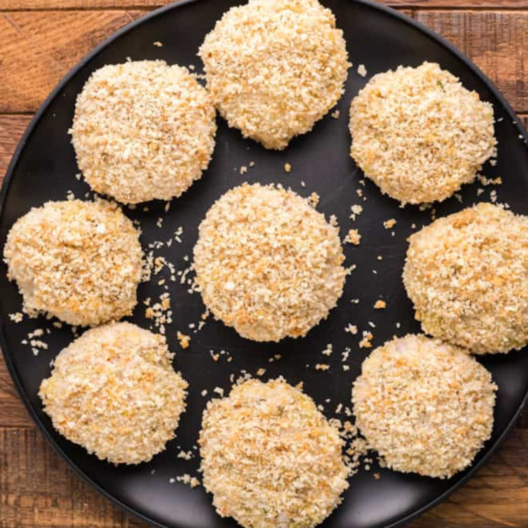 Shaping the chicken mixture into small croquettes.