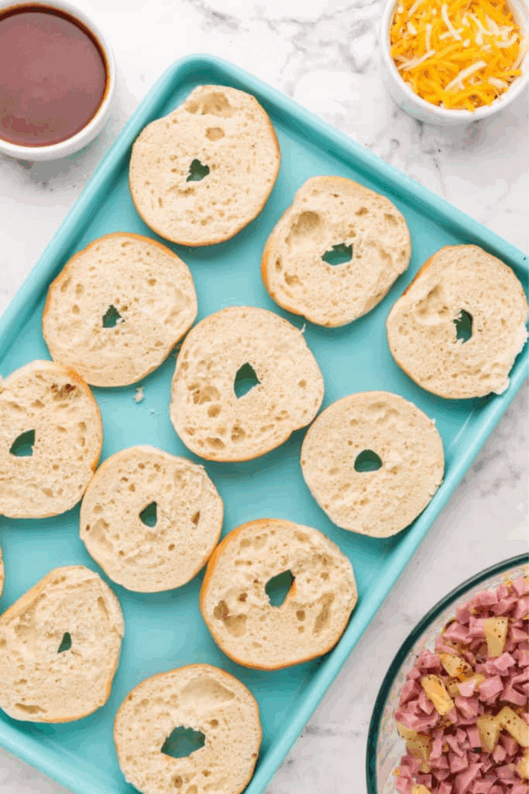 Place cut bagels on a cutting board or flat surface.