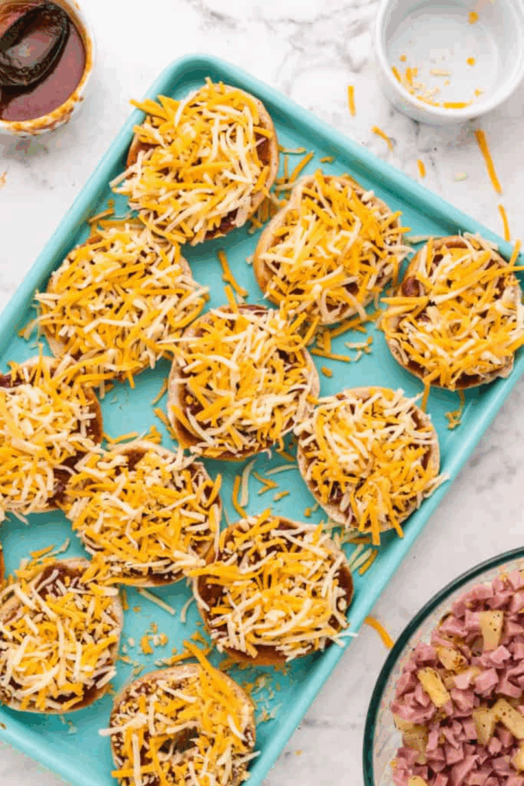 Sprinkle cheese on top of the pizza sauce.