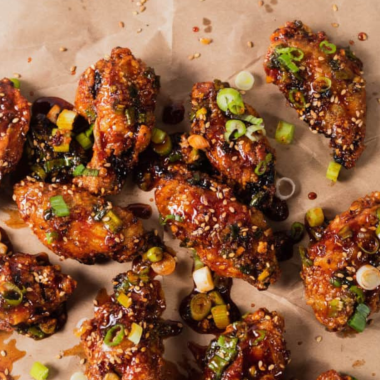 "Plate of crispy Air Fryer Korean Chicken Wings with a sweet and spicy glaze"