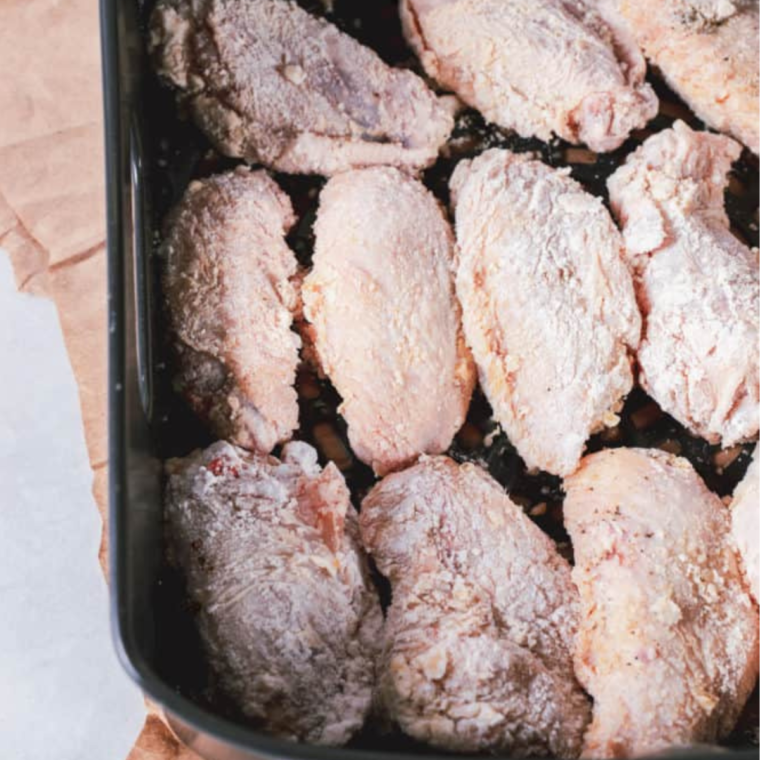 Place the chicken wings into the air fryer basket, leaving space in between, for the air-flow.