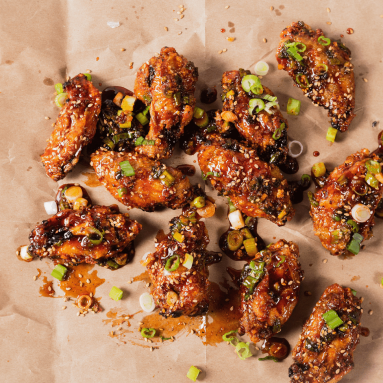 Plate of crispy Air Fryer Korean Chicken Wings glazed with a sweet and spicy sauce"