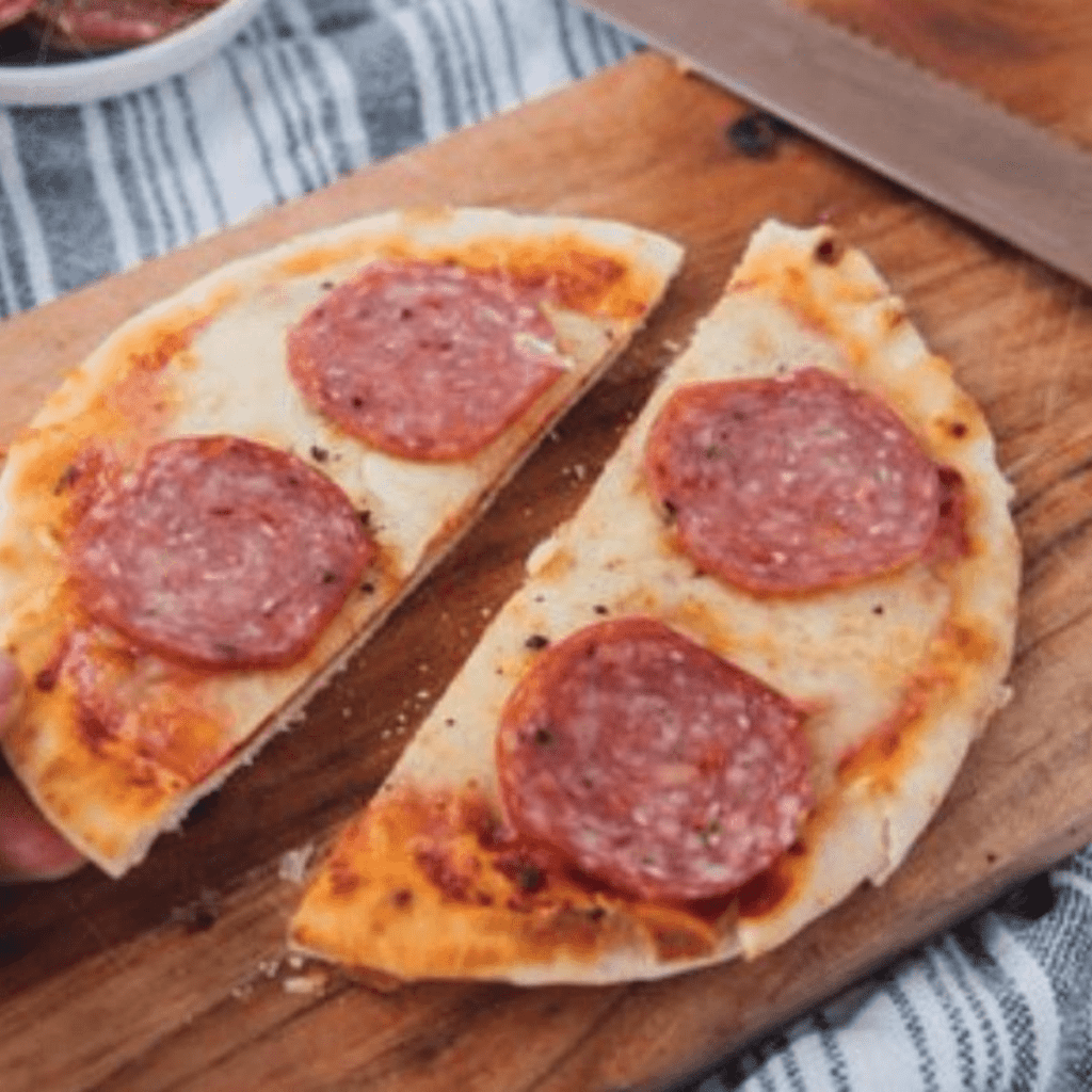 Naan Pizza on Cutting Board with Pepperoni on top