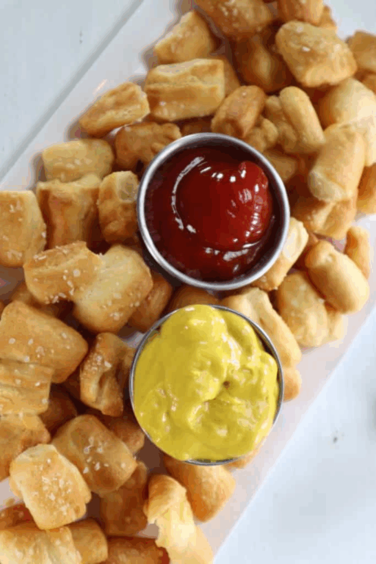 Plate of Air Fryer Pretzel With Pizza Dough with ketchup and mustard for dipping sauces.
