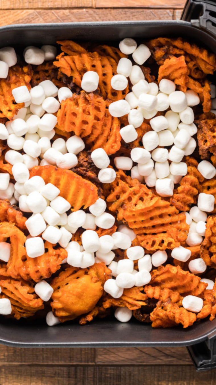 Sweet potato nachos in air fryer with marshmallows on top.