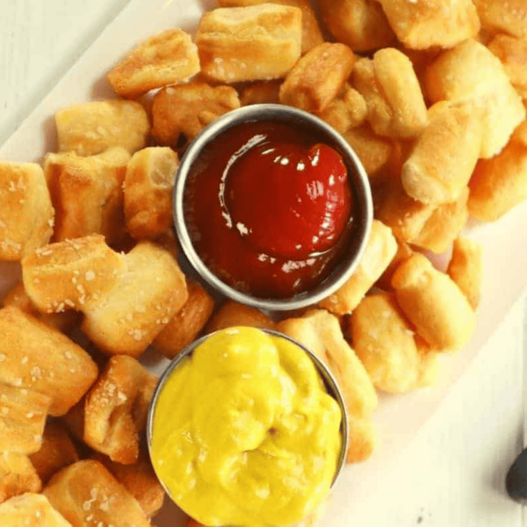 Plate of golden brown Culver&rsquo;s Famous Warm Pretzel Bites (with dipping sauce)
