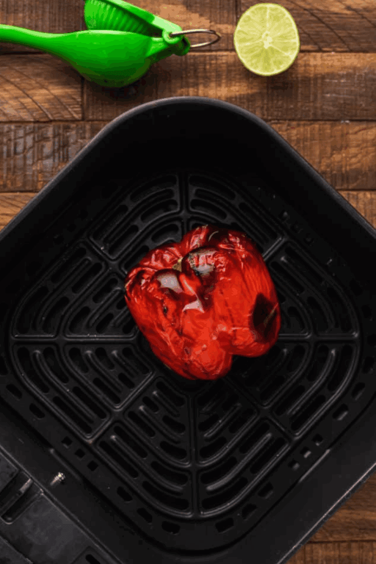 Roasting red pepper in the air fryer, then chopping and adding it to a saucepan with guava BBQ sauce ingredients.