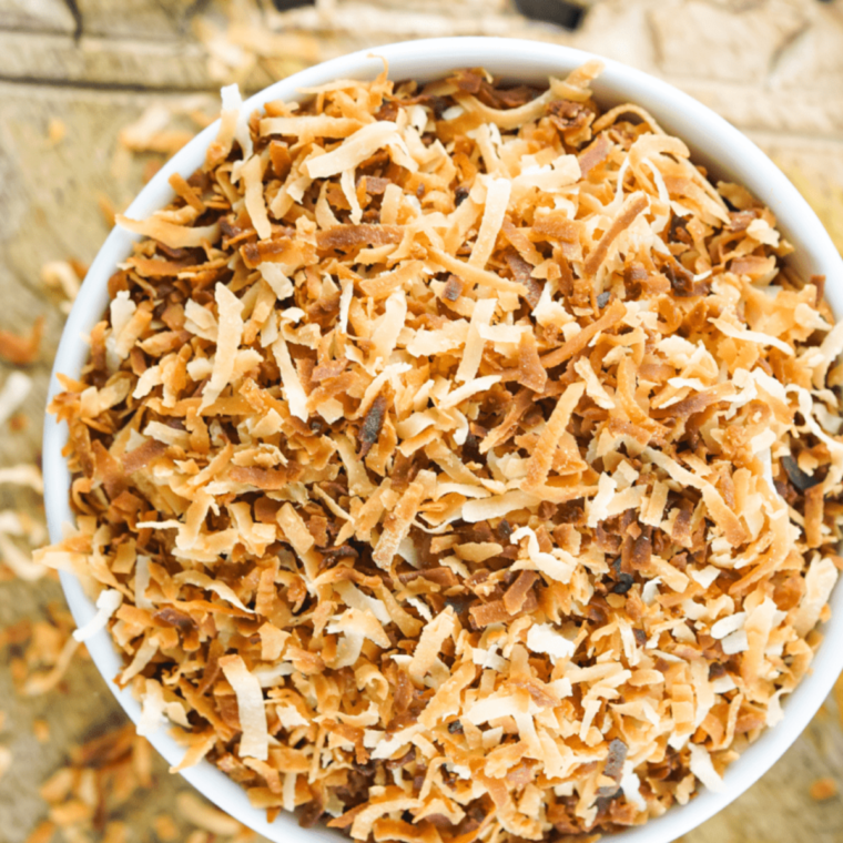 Coconut flakes being stirred in the air fryer