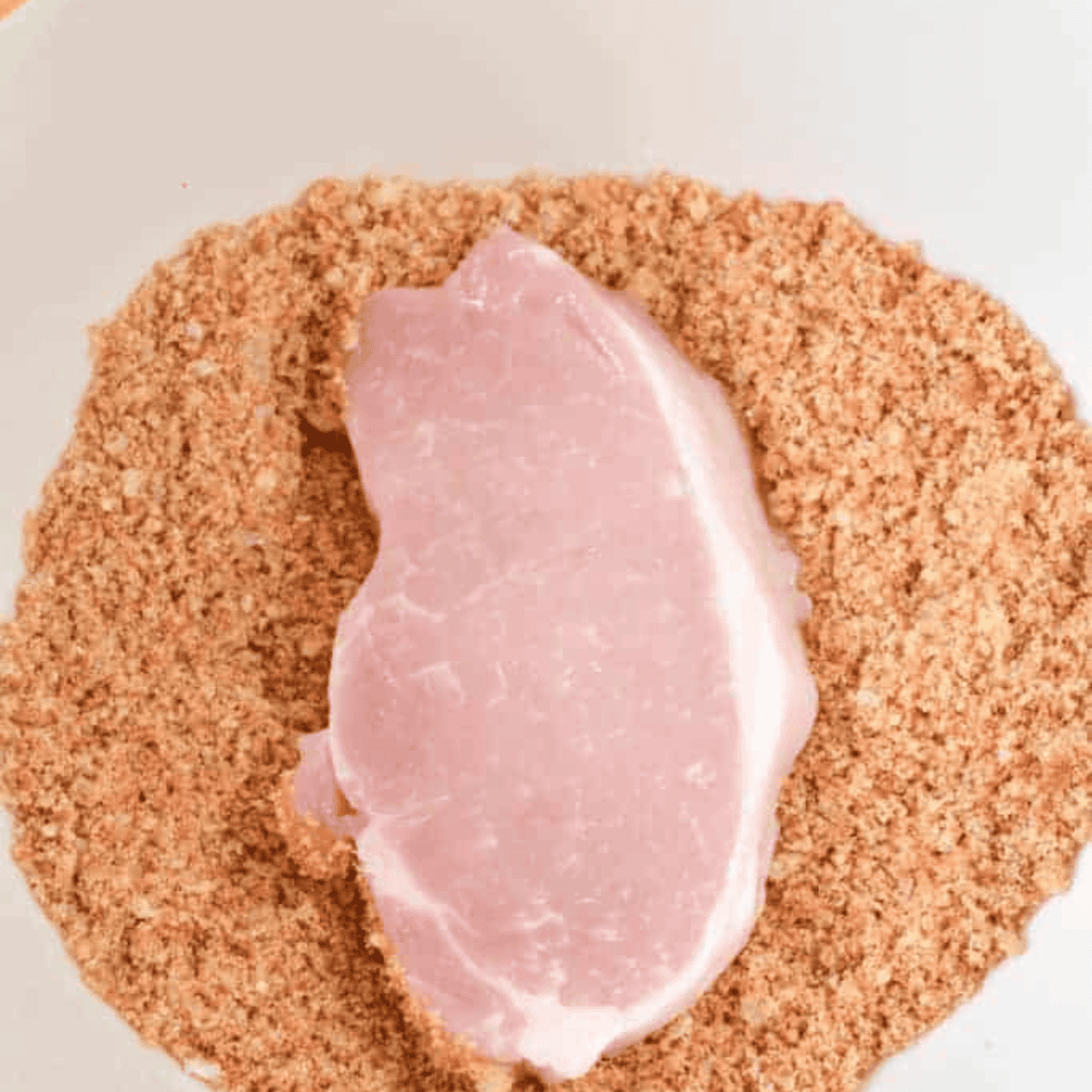 Place Keto Shake and Bake in a large bowl, to coat the chicken or the pork chops.