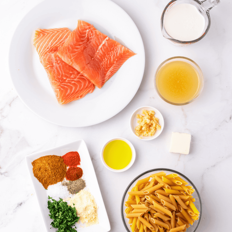 Ingredients for air fryer Old Bay salmon: salmon fillets, olive oil, Old Bay seasoning, garlic powder, onion powder, smoked paprika, dried dill, and lemon