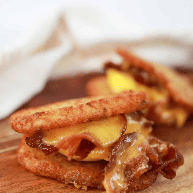 side view closeup: trader joes hashbrown air fryer recipe used as bread in bacon, egg, and cheese sandwich