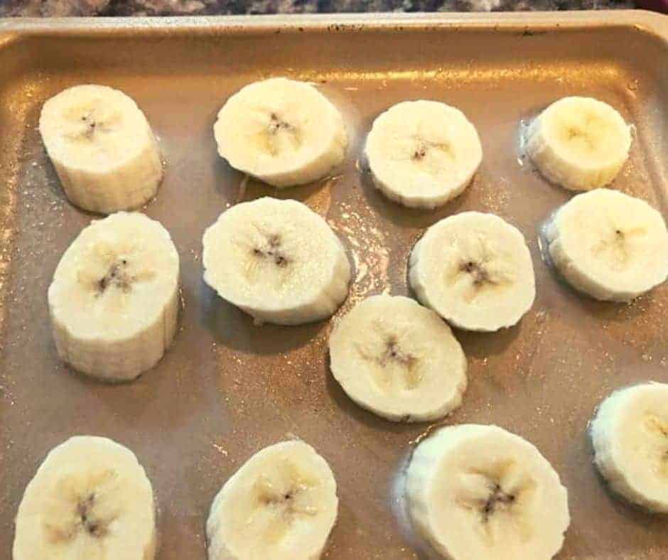 sliced bananas on a prepared air fryer tray