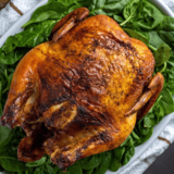 Can I use a soda can instead of a beer can for Beer Can Chicken in the air fryer? Yes, you can use a soda can or any other beverage can instead of a beer can. The choice of liquid can vary based on your flavor preferences. 2. Can I cook a larger chicken in the air fryer using the Beer Can Chicken method? The size of the chicken should fit comfortably in your air fryer basket. Be mindful of the air fryer's capacity when selecting the chicken to ensure it cooks evenly. 3. Do I need to remove the giblets from the chicken before cooking it in the air fryer? Yes, it's essential to remove the giblets and any other internal organs from the chicken before cooking it. 4. Can I cook Beer Can Chicken in an oven instead of an air fryer? Yes, the Beer Can Chicken method can be adapted for oven cooking. Preheat your oven to the recommended temperature and follow the same instructions, placing the chicken on a can in a roasting pan. 5. What should I do if my air fryer is too small for a whole chicken on a beer can? If your air fryer is too small for a whole chicken on a beer can, consider using chicken parts like thighs or drumsticks instead. You can still achieve a similar flavor infusion and crispy texture. 6. How can I prevent the chicken skin from sticking to the air fryer basket? Preheating your air fryer and lightly oiling the chicken's skin can help prevent it from sticking to the basket. You can also use parchment paper or a non-stick liner to further prevent sticking. 7. Can I use other liquids besides beer for Beer Can Chicken in the air fryer? Absolutely! You can use a variety of liquids like soda, fruit juices, or even broth to add flavor and moisture to your chicken. 8. How do I know when the Beer Can Chicken is done cooking in the air fryer? Use a meat thermometer to check the internal temperature of the chicken. It should reach 165°F (74°C) in the thickest part of the meat to ensure it's safe to eat.